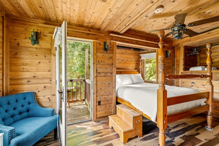 Cedar-paneled bedroom with French doors to the deck