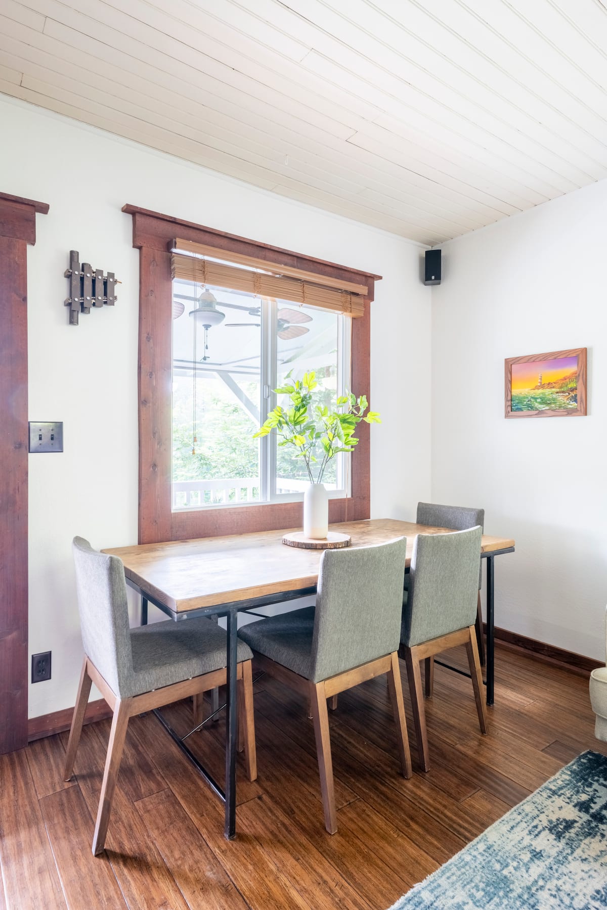 Bright dining nook with wood trim window