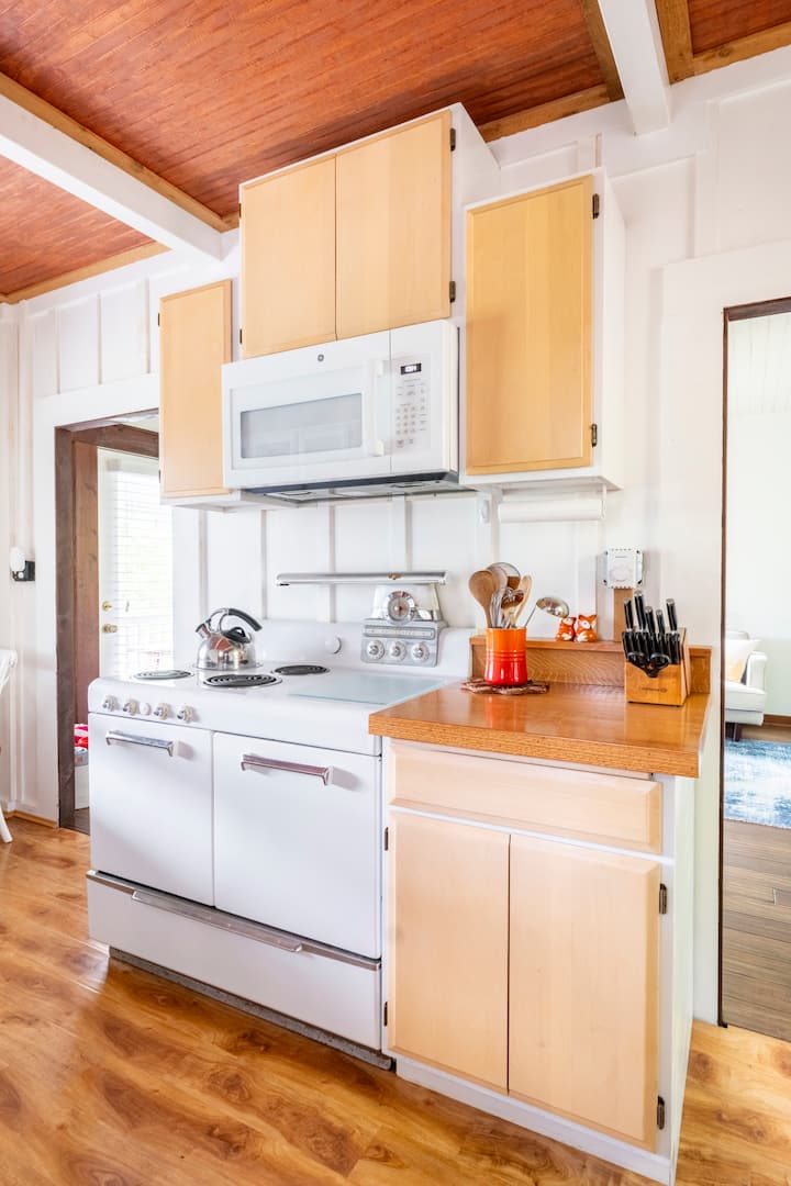 Vintage white stove with chrome details in the cabin kitchen