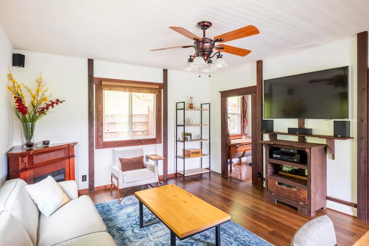 Bright living room with ceiling fan and dining nook